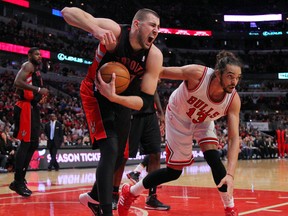 Toronto Raptors centre Jonas Valanciunas (17) reacts to being fouled by Chicago Bulls centre Joakim Noah (13) during the second half at the United Center. Toronto won 85-79. (DENNIS WIERZBICKI/USA TODAY Sports)
