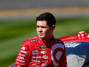 Kyle Larson leans on his No. 42 Target Chevrolet during qualifying for the Daytona 500 on Sunday. (AFP)