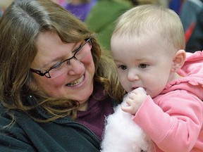 CHRIS ABBOTT/TILLSONBURG NEWS
Elena Robillard-Mardue, with her grandmother Tammy Westra, samples some cotton candy at the Family Day carnival Monday afternoon in the Tillsonburg Community Centre Lions Auditorium.