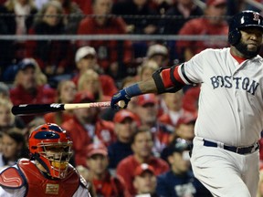 Boston Red Sox first baseman David Ortiz hits a RBI double against the St. Louis Cardinals in the first inning during Game 5 of the World Series at Busch Stadium. (H.Darr Beiser/USA TODAY Sports)