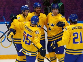 Sweden's Daniel Sedin (C, 22) celebrates his goal against Slovenia with his linemates during the third period of their men's quarterfinals ice hockey game at the 2014 Sochi Winter Olympic Games, February 19, 2014. (REUTERS)