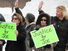 Stacey Grove, left, and Paula Foster were two of more than 20 people calling for stiffer animal cruelty penalties outside the Sarnia Courthouse Wednesday. A 19-year-old man charged with shooting a cat named Joe 17 times in the head with a pellet gun was appearing for a bail hearing. Group members wave as motorists honk in support. TYLER KULA/ THE OBSERVER/ QMI AGENCY