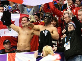 A fan wearing blackface and holding a P.K. Subban jersey watching Canada take on Latvia in their hockey quarterfinal at the 2014 Sochi Winter Olympic Games, Feb. 19, 2014. (BEN PELOSSE/QMI Agency)