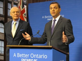 Ontario PC MPP Doug Holyday, left,  and PC Leader Tim Hudak introduce legislation on Feb. 19, 2014 which would open up more public sector services to competitive bidding. (Antonella Artuso/Toronto Sun)