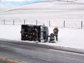 Icy roads were to blame for this van losing control and spilling into the ditch. No injuries were reported. Greg Cowan photo/QMI agency.
