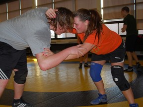 Central Elgin Collegiate wrestler Eric Smith, left, grapples with teammate Mackenzie Gosse at a practice in the school cafeteria. (Ben Forrest, Times-Journal)