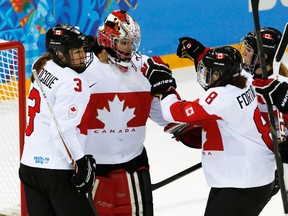 Canada's goalie Shannon Szabados is congratulated by teammates after defeating Switzerland in their women's hockey semifinal game at the Sochi 2014 Winter Olympic Games, Feb. 17, 2014. (GRIGORY DUKOR/Reuters)