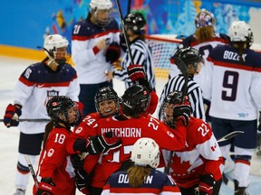 Canada's Hayley Wickenheiser (22) celebrates her goal with teammates against Team USA's goalie Jessie Vetter during the third period of their women's ice hockey game at the 2014 Sochi Winter Olympics, February 12, 2014. (REUTERS)