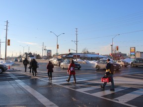 Pedestrians cross the street at the bustling intersection at Wonderland Rd. and Southdale Rd.