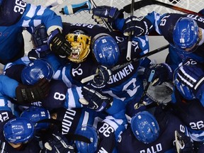 Finland's players celebrate a 3-1 quarterfinal victory over Russia this week. (AFP PHOTO / ALEXANDER NEMENOV)