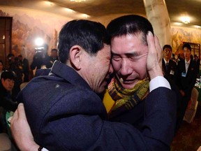 South Korean Park Yang-gon, 53, and his North Korean brother Park Yang-su, who was abducted by North Korea, cry during their family reunion at the Mount Kumgang resort in North Korea, February 20, 2014. REUTERS/Korea Pool/News1