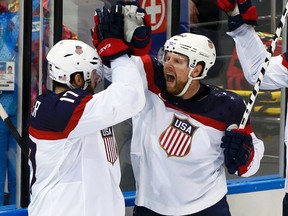 Team USA's Phil Kessel (right) is congratulated by teammate Ryan Kesler after scoring a goal against Czech Republic during their men's quarterfinal hockey game at the 2014 Sochi Winter Olympic Games, Feb. 19, 2014. (GRIGORY DUKOR/Reuters)