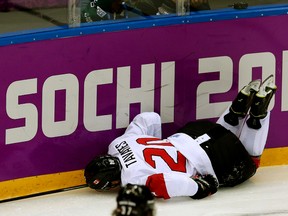 John Tavares hits the ice hard after catching his leg along the boards in the second period against Team Latvia at the Sochi 2014 Winter Olympics in Sochi, Russia, on Feb. 19, 2014. (Al Charest/Calgary Sun/QMI Agency)