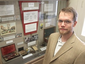 Robert Engen stands in front of his newly-opened display at the Museum of Health Care in Kingston, which documents how disease has killed more soldiers than their enemies have during history's wars. 
MICHAEL LEA\THE WHIG STANDARD\QMI AGENCY