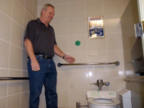 Doug Marks, director of terminal services, explains that with a simple wave of your hand, a new plastic, sanitary toilet seat cover comes out of their new toilet seats installed in the public washrooms at the Grande Prairie Airport in Grande Prairie Alberta on Thursday, Feb. 13, 2014. JOCELYN TURNER/QMI AGENCY
