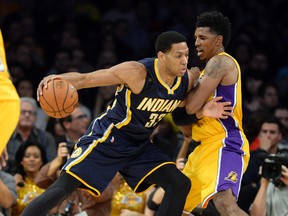 Los Angeles Lakers forward Nick Young defends against Indiana Pacers forward Danny Granger (33) during the first half at Staples Center Jan. 28, 2014. (Richard Mackson/USA TODAY Sports)