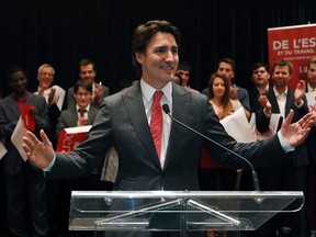 Liberal leader Justin Trudeau acknowledges applause from supporters during a rally at the Hilton hotel in Quebec City, February 19, 2014. REUTERS/Mathieu Belanger