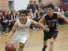Moe Bhatda of the Frontenac Falcons fends off Jayson Brown of the Thousand Islands Pirates and takes the ball toward the basket in the Eastern Ontario Secondary Schools Athletic Association senior boys AAA championship game Thursday at Frontenac. The Falcons won the game 53-22 to advance to the Ontario Federation of School Athletic Associations tournament in Welland, March 3-5. Frontenac also won the junior game, 40-38 over the Pirates. (Tim Gordanier/The Whig-Standard)