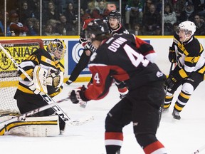 Kingston Frontenacs goalie Lucas Peressini makes the save on a shot by the Niagara IceDogs Vince Dunn during an OHL game in St. Catharines on Thursday night. (Bob Tymczyszyn//QMI Agency)