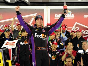 Denny Hamlin celebrates in Victory Lane after winning the NASCAR Sprint Cup Series Budweiser Duel 2 at Daytona International Speedway on Thursday night. (GETTY IMAGES/PHOTO)
