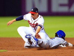 Atlanta Braves shortstop Andrelton Simmons tags out Los Angeles Dodgers shortstop Dee Gordon on a stolen base attempt during Game 2 of the National League divisional series at Turner Field. (Daniel Shirey/USA TODAY Sports)