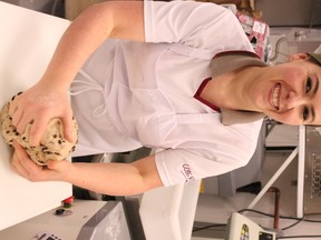 Jelena Reich prepares Hot Cross Chocolate Chip buns and Apricot Delight loaves, two popular items at their COBS Bakery franchise in Spruce Grove. The couple opened their doors six months ago and have since worked together nearly everyday. - Karen Haynes, Reporter/Examiner