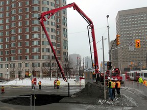 Ottawa crews work on a sink hole in Waller St. in Ottawa on Friday Feb 21, 2014. Tony Caldwell/Ottawa Sun/QMI Agency