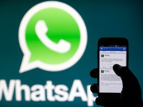A Whatsapp App logo is seen behind a Samsung Galaxy S4 phone that is logged on to Facebook in the central Bosnian town of Zenica, February 20, 2014. (REUTERS/Dado Ruvic)