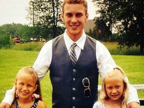 Danny Gibbons is shown with his two youngest sisters in this photo from a recently created Facebook page in his name. The 21-year-old Petrolia man is in a coma in London hospital after he was a passenger in a rollover crash Feb. 13. (Submitted photo)