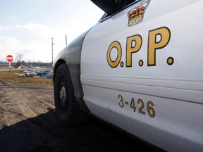 An Ontario Provincial Police cruiser sits on a near a highway in Belleville, Ont., in this Jan. 16, 2013 file photo.  (QMI Agency files)