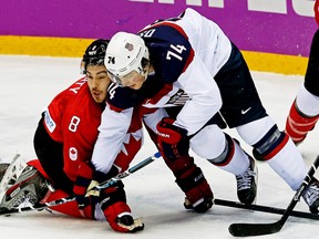 Canada's Drew Doughty and Team USA's T.J. Oshie tangleduring their men's hockey semifinal game at the Sochi 2014 Winter Olympics, Feb. 21, 2014. (AL CHAREST/QMI Agency)