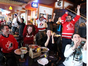 Hockey fans celebrate Canada's 1-0 win over the United States in a men's Olympic semifinal at Tavern United MTS Centre in downtown Winnipeg, Man., on Fri., Feb. 21, 2014. Licensed establishments were given an option to open early on Sunday for the gold-medal game against Sweden. Kevin King/Winnipeg Sun/QMI Agency