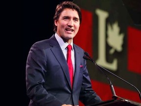 Liberal leader Justin Trudeau delivers his opening speech at the Liberal Biennial Convention in Montreal, February 20, 2014. REUTERS/Christinne Muschi