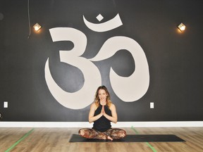 Danielle Murray practices a yoga position at Sanatosa Hot Yoga and Wellness. Murray is holding Karma Yoga sessioins at Santotosa every Friday to raise money for the Do Something cancer fundraising campaign.
Barry Kerton | Whitecourt Star