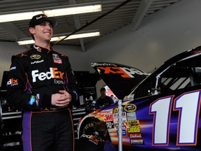 Denny Hamlin, driver of the #11 FedEx Express Toyota, stands in the garage area during practice for the NASCAR Sprint Cup Series Daytona 500 at Daytona International Speedway yesterday. (AFP/photo)