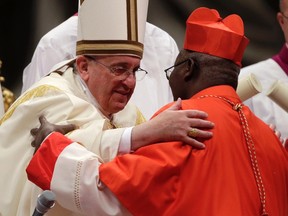 Pope Francis embraces newly elected cardinal Philippe Nakellentuba Ouedraogo of Burkina Faso during a consistory ceremony in Saint Peter's Basilica at the Vatican February 22, 2014. Pope Francis will install 19 new Roman Catholic cardinals from around the world on Saturday.  REUTERS/Max Rossi