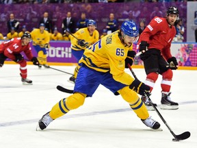 Sweden's Erik Karlsson breaks in across the blueline against Switzerland during their men's hockey game at the Sochi 2014 Winter Olympics, Feb. 14, 2014. (BEN PELOSSE/QMI Agency)