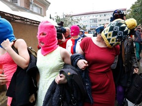 Masked members of protest band Pussy Riot leave a police station in Adler during the 2014 Sochi Winter Olympics, February 18, 2014. (REUTERS)