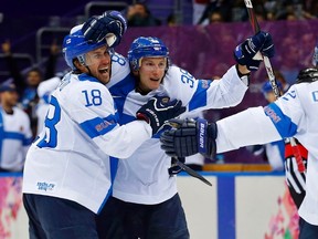 Finland's Juuso Hietanen (C) celebrates his goal against Team USA with teammates Sami Lepisto (L) and Olli Jokinen during the third period of their men's ice hockey bronze medal game at the Sochi 2014 Winter Olympic Games February 22, 2014. (REUTERS)