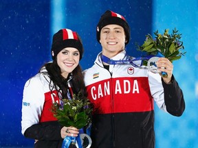 Silver medallists Canada's Tessa Virtue and Scott Moir celebrate during the medal ceremony for the figure skating ice dance free dance program at the 2014 Sochi Winter Olympics February 18, 2014.  (REUTERS)
