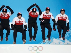 Canada's Brad Jacobs (left to right), Ryan Fry, E.J. Harnden, Ryan Harnden and Caleb Flaxey celebrate during the medal ceremony for men's curling at the 2014 Sochi Winter Olympics, Feb. 22, 2014. (ERIC GAILLARD/Reuters)