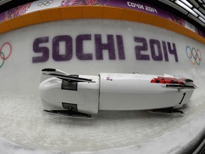 Canada 3 flips over during its second heat at the Sanki Sliding Center in Sochi, Russia, on Saturday, February 22, 2014. (Didier Debusschere/QMI Agency)