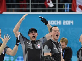 Canadian men's curling team celebrate their gold medal win against Great Britain at the Sochi Olympics in Russia, Feb. 21, 2014. (Ben Pelosse/Journal de Montreal/QMI Agency)