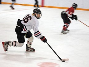 Vulcan Midget Hawk Brayden Kohut skates the puck up the ice towards the Airdrie Minor Hockey Association’s zone Friday evening at the Vulcan Iceplex during first period action in the teams’ first game in the opening round of playoffs in the Central Alberta Hockey League. The Hawks initially struggled against Airdrie, which was in the lead 3-1 with minutes to go in the third period. But two quick goals led to overtime, and the Hawks went on to win 4-3. The second game was played Saturday in Airdrie, and the Hawks won 7-1, moving them on to the next round of playoffs.