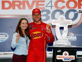 Regan Smith, driver of the #7 Ragu Chevrolet, celebrates in Victory Lane with his wife Megan Mayhew after winning the NASCAR Nationwide Series DRIVE4COPD 300 at Daytona International Speedway on Feb. 22. (AFP)