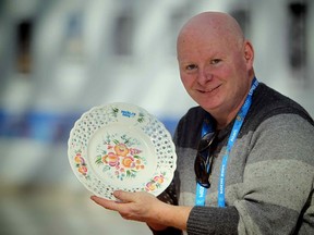 Steve Buffery of the Toronto Sun holding his Sochi14 plate, awarded by the International Sports Writers Association, to commemorate covering his sixth Winter Olympics. (Al Charest/QMI Agency)