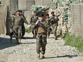 In this photograph taken on April 14, 2013, Afghan National Army soldiers are pictured in Afghanistan's eastern Kunar province. The Taliban stormed an Afghan army outpost in the eastern Kunar province bordering Pakistan early February 23, 2014, killing 20 soldiers and kidnapping seven, an official said. The volatile border area is dominated by militants who often use improvised explosive devices to target soldiers, but Sunday's attack saw the highest casualty count in a single incident in recent months. AFP PHOTO/MANJUNATH KIRAN/FILES