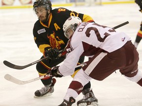 Cameron Brace of the Belleville Bulls battles for position with Peterborough's Michael Clarke during OHL action Sunday at Yardmen Arena. (EMILY MOUNTNEY/The Intelligencer)