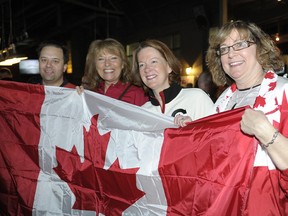 Alberta Premier Alison Redford, second from right, and Justice Minister Jonathan Denis, far left, watch the Olympic mens' gold medal game Sunday morning. Canada defeated Sweden. (SUPPLIED)
