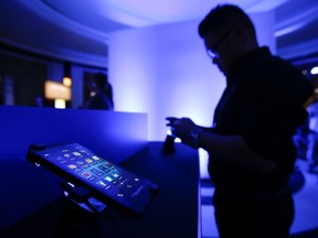 A Blackberry marketing employee tries out the new  BlackBerry Z10 during the launch of the BlackBerry 10 platform at the Carlu in downtown  Toronto, Ont. on Wednesday Jan. 30, 2013. (Ernest Doroszuk/QMI Agency files)